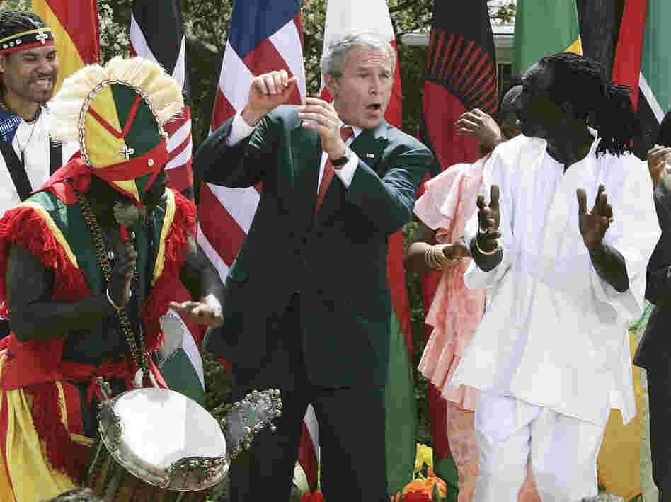 President George W. Bush dances with members of the KanKouran West African Dance Company during a Rose Garden event to mark Malaria Awareness Day at the White House on April 25, 2007.