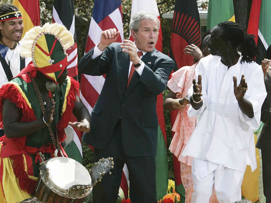 President George W. Bush dances with members of the KanKouran West African Dance Company during a Rose Garden event to mark Malaria Awareness Day at the White House on April 25, 2007.