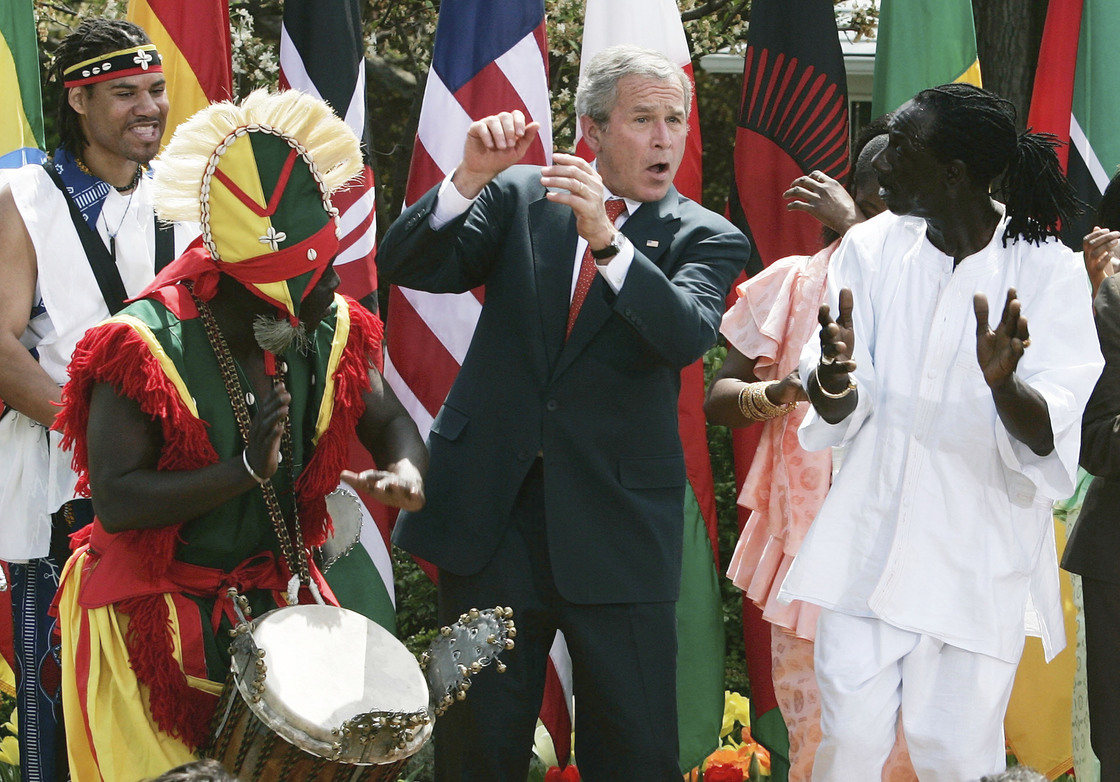 President George W. Bush dances with members of the KanKouran West African Dance Company during a Rose Garden event to mark Malaria Awareness Day at the White House on April 25, 2007.