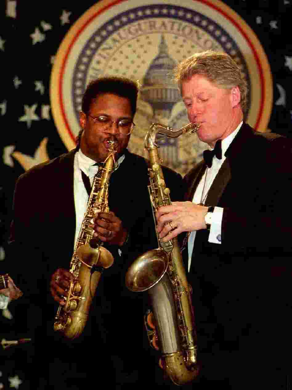 President Bill Clinton plays a saxophone with Everette Harp at the Arkansas inaugural ball on Jan. 20, 1993.