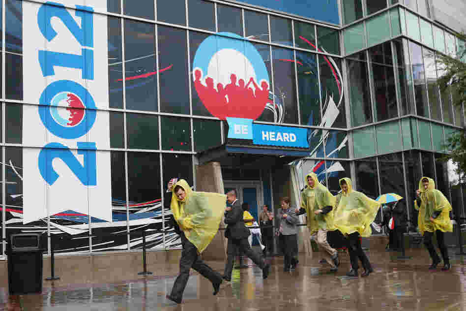 People run for cover outside the convention center.