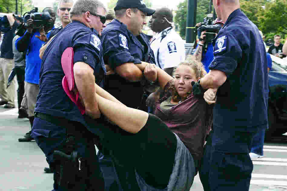 Police arrest protesters who were blocking traffic at an intersection in Charlotte before the convention Thursday. 