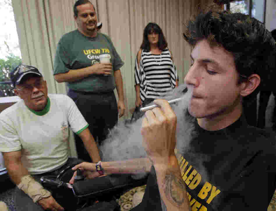 Medical cannabis patient Michael Oliveri smokes marijuana during a news conference in Universal City, Calif., last week. Medical marijuana advocates say they have enough signatures to place a referendum before voters that would overturn a ban on pot clinics in Los Angeles.