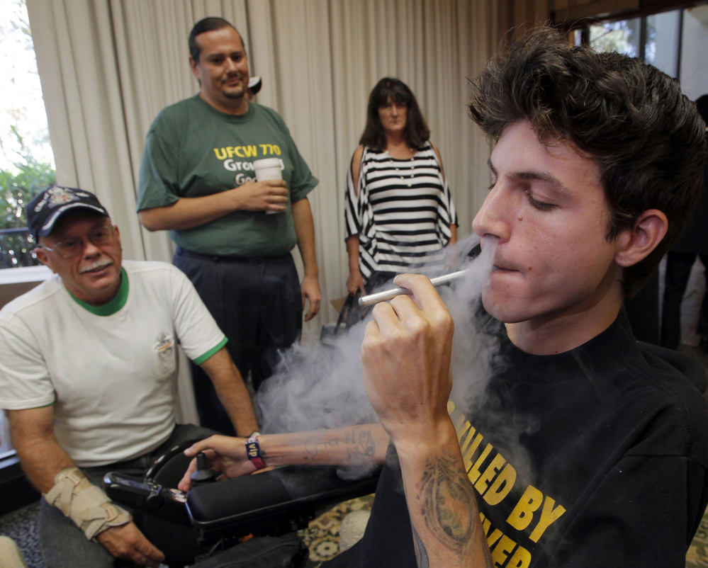 Medical cannabis patient Michael Oliveri smokes marijuana during a news conference in Universal City, Calif., last week. Medical marijuana advocates say they have enough signatures to place a referendum before voters that would overturn a ban on pot clinics in Los Angeles.