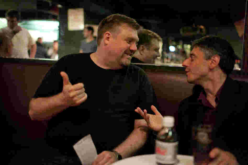 Versace (right) chats with saxophonist Joel Frahm, who came by to watch from the audience.