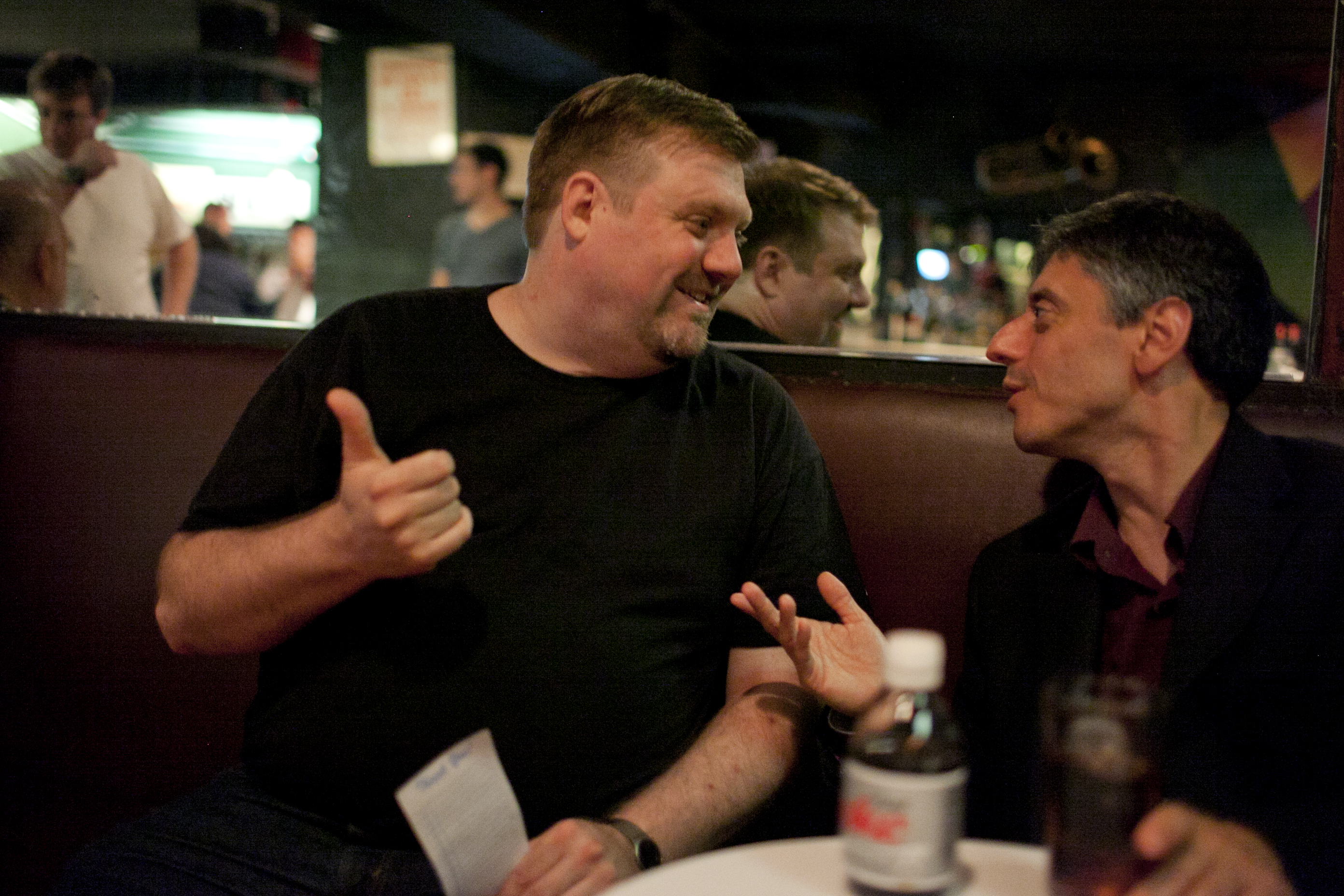 Versace (right) chats with saxophonist Joel Frahm, who came by to watch from the audience.