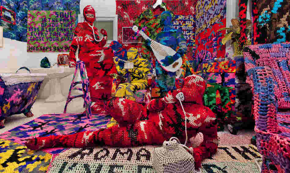 Knitting Is for Pus**** is a work by crochet sculptor Olek. He has created an entire apartment blanketed in brightly colored, crocheted camouflage. Knitting Is for Pus**** is a work by crochet sculptor Olek. He has created an entire apartment blanketed in brightly colored, crocheted camouflage.