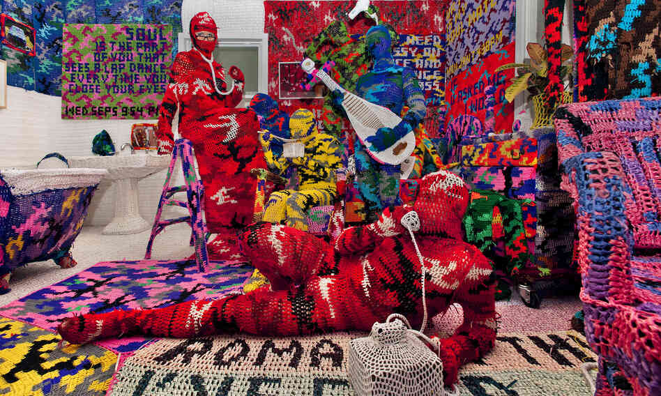 Knitting Is for Pus**** is a work by crochet sculptor Olek. He has created an entire apartment blanketed in brightly colored, crocheted camouflage. Knitting Is for Pus**** is a work by crochet sculptor Olek. He has created an entire apartment blanketed in brightly colored, crocheted camouflage.