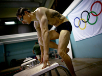 Lt. Brad Snyder mounts the starting blocks while training on his starting technique. Snyder was permanently blinded last year by an IED in Afghanistan, and is now competing in the Paralympics in London.