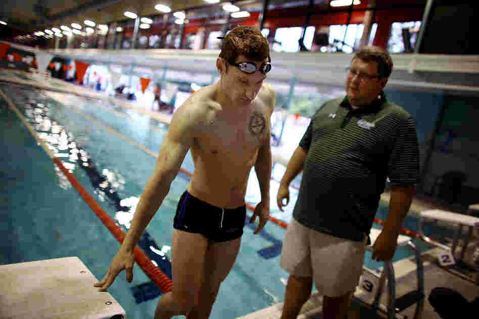 Navy Lt. Brad Snyder talks with his coach, Brian Loeffler, during a training session at the North Baltimore Swim Club in Maryland on July 29. Last year the lieutenant was working on a bomb-disposal squad in Afghanistan when an improvised explosive device took his vision.