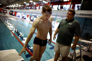 Navy Lt. Brad Snyder talks with his coach, Brian Loeffler, during a training session at the North Baltimore Swim Club in Maryland on July 29. Last year the lieutenant was working on a bomb-disposal squad in Afghanistan when an improvised explosive device took his vision.