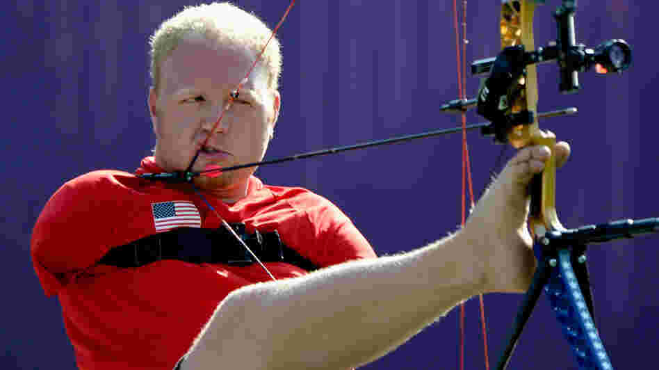 Archer Matt Stutzman of the U.S. prepares to shoot in the London Paralympics. Born without arms, Stutzman uses a release trigger strapped to his shoulder to fire.