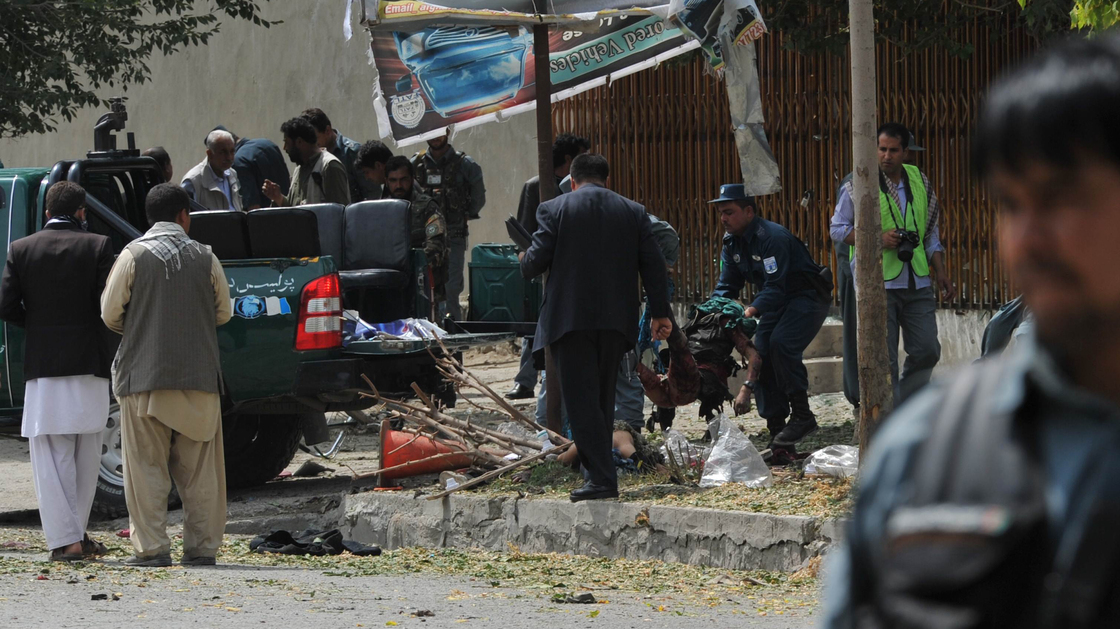 Afghan police carry the remains of a suicide attack victim in the Kabul's diplomatic quarters, home to many Western embassies, on Saturday.