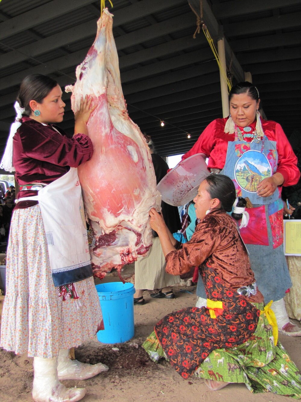 Miss Navajo contestants must work in teams to butcher sheep. From left, Wallitta Begay, Leandra "Abby" Thomas and Charlene Goodluck had to cut the sheep's throat, remove the stomach and quarter the carcass. Miss Navajo contestants must work in teams to butcher sheep. From left, Wallitta Begay, Leandra "Abby" Thomas and Charlene Goodluck had to cut the sheep's throat, remove the stomach and quarter the carcass.