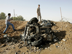 Iraqis inspect the site of a blast near the state-owned North Oil Company, about nine miles from the northern city of Kirkuk Sunday.