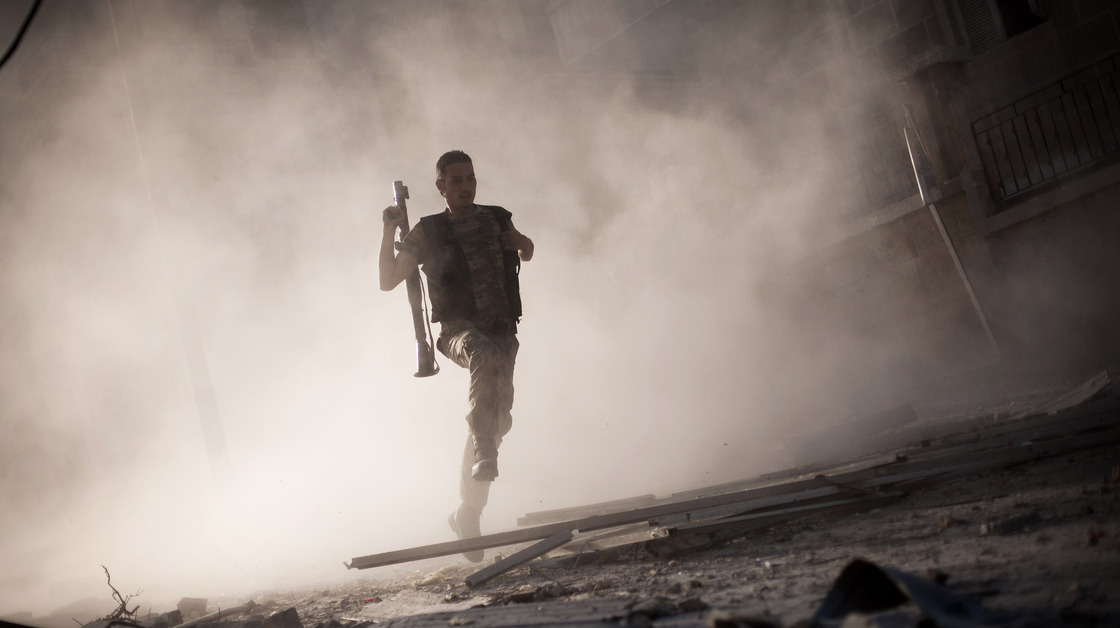 A rebel fighter fled after attacking a tank with a rocket-propelled grenade last week in Aleppo, Syria. The escalating Syrian conflict is among several issues in the Middle East that the next U.S. president must confront.