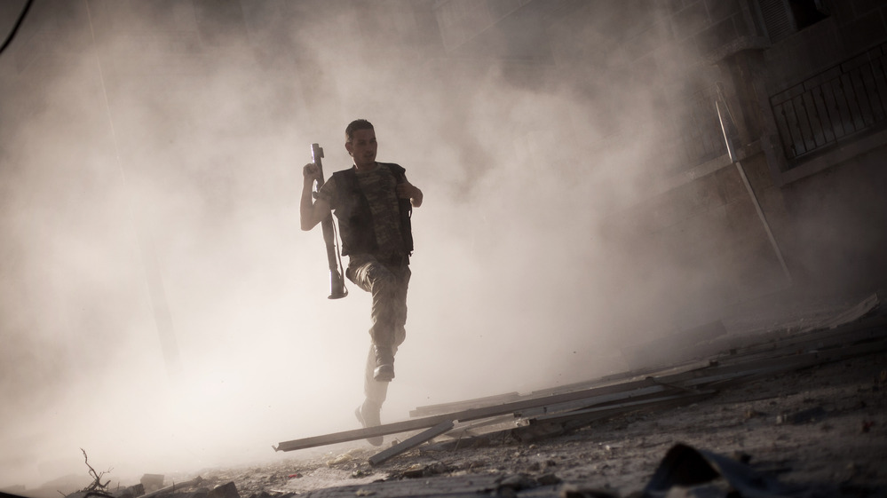 A rebel fighter fled after attacking a tank with a rocket-propelled grenade last week in Aleppo, Syria. The escalating Syrian conflict is among several issues in the Middle East that the next U.S. president must confront.