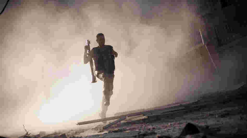 A rebel fighter fled after attacking a tank with a rocket-propelled grenade last week in Aleppo, Syria. The escalating Syrian conflict is among several issues in the Middle East that the next U.S. president must confront.