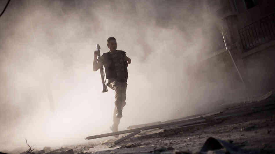 A rebel fighter fled after attacking a tank with a rocket-propelled grenade last week in Aleppo, Syria. The escalating Syrian conflict is among several issues in the Middle East that the next U.S. president must confront.