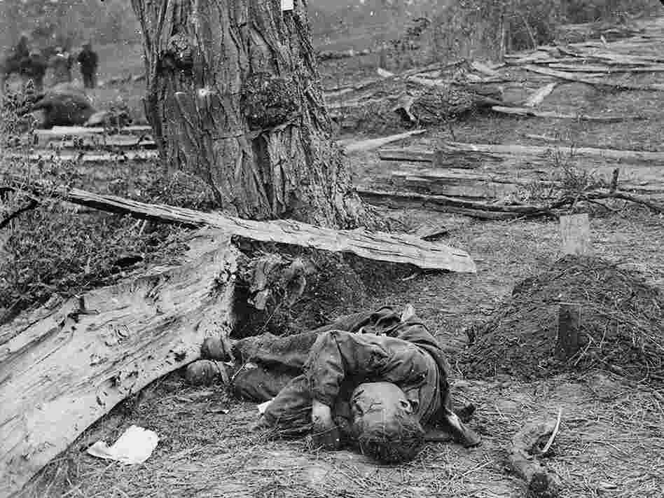 Gardner's caption for this photograph: "A Contrast: Federal buried, Confederate unburied, where they fell on the Battle-field of Antietam."