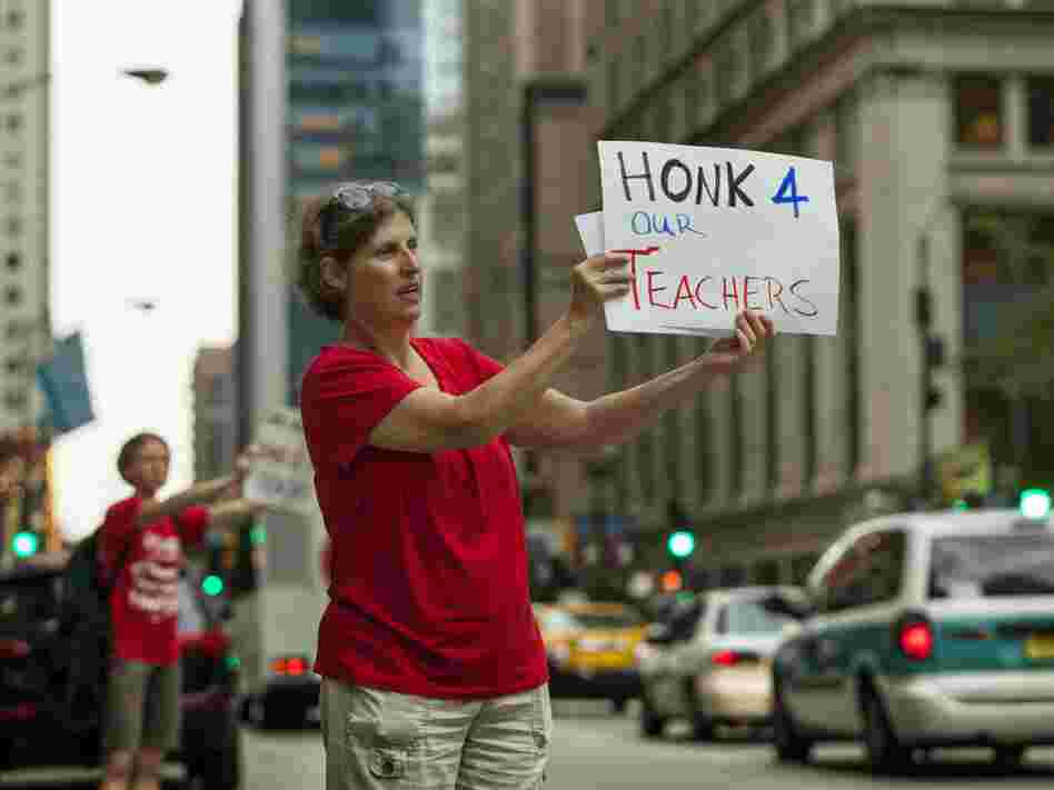 Members of community group Parents 4 Teachers display pro-teacher posters outside City Hall Friday in Chicago. The Chicago Teachers Union has threatened to strike Monday if negotiations fail.