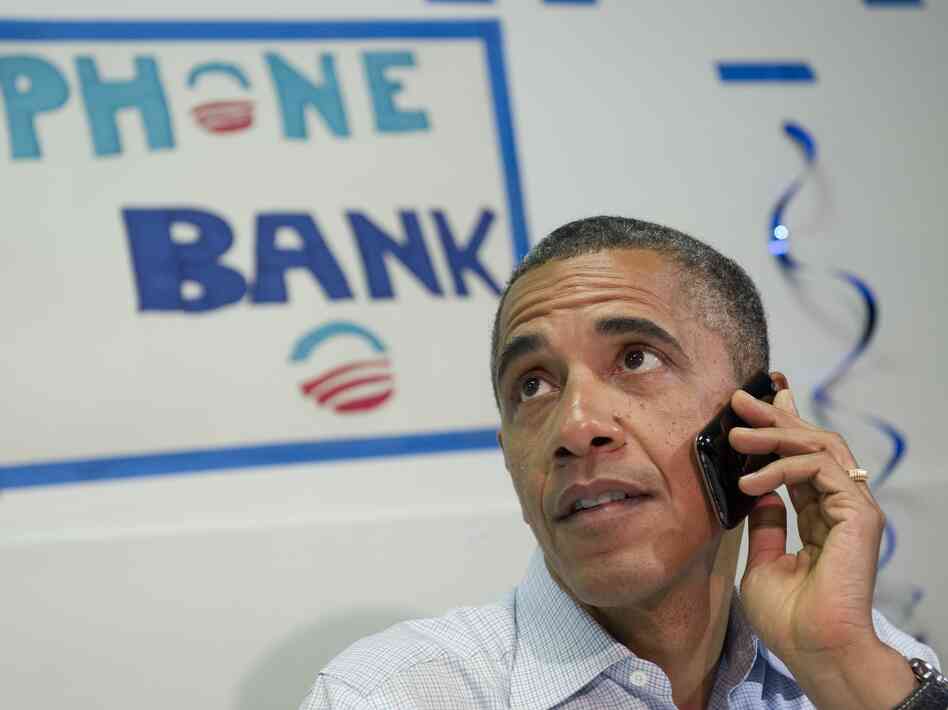 President Barack Obama makes a phone call to a supporter during a visit to the Obama for American campaign field office in Port St. Lucie, Florida, on September 9, 2012, during the second day of a 2-day bus tour across Florida.