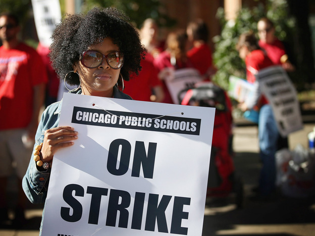 Chicago public school teachers picket outside William H.Wells Community High School on Monday. Chicago public school teachers picket outside William H.Wells Community High School on Monday.