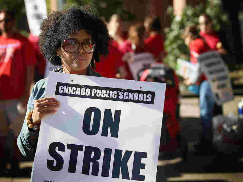 Chicago public school teachers picket outside William H.Wells Community High School on Monday.