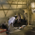 Afghan detainees, seen through a mesh wire fence in March 2011, prepare for noon prayers inside the Parwan detention facility near Bagram Air Field in Afghanistan. On Monday, U.S. officials handed over formal control of the prison to Kabul.