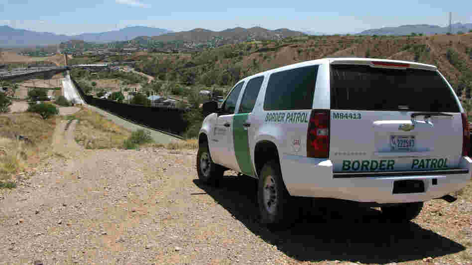 A Border Patrol vehicle patrols the fence separating the cities of Nogales, Ariz., and Nogales, Sonora. The fence has been rebuilt twice.