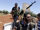 Rebel fighters take up position near the military airport outside the rebel-held town of Azaz in northern Syria on Aug. 21. In rebel-held towns like Azaz, activists are taking on new, risky roles as the uprising against Syrian President Bashar Assad continues. Rebel fighters take up position near the military airport outside the rebel-held town of Azaz in northern Syria on Aug. 21. In rebel-held towns like Azaz, activists are taking on new, risky roles as the uprising against Syrian President Bashar Assad continues.