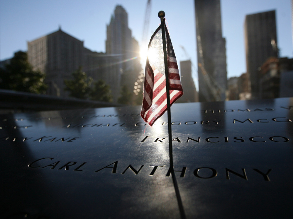 A flag sits atop one of the memorial panels at the World Trade Center site in New York City on Tuesday.