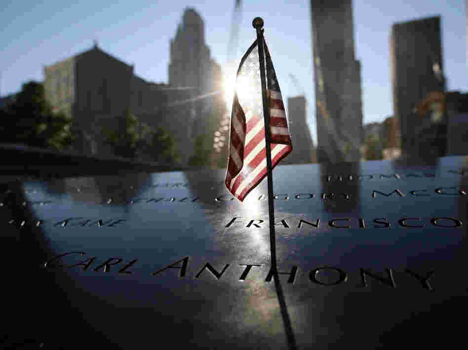 A flag sits atop one of the memorial panels at the World Trade Center site in New York City on Tuesday.