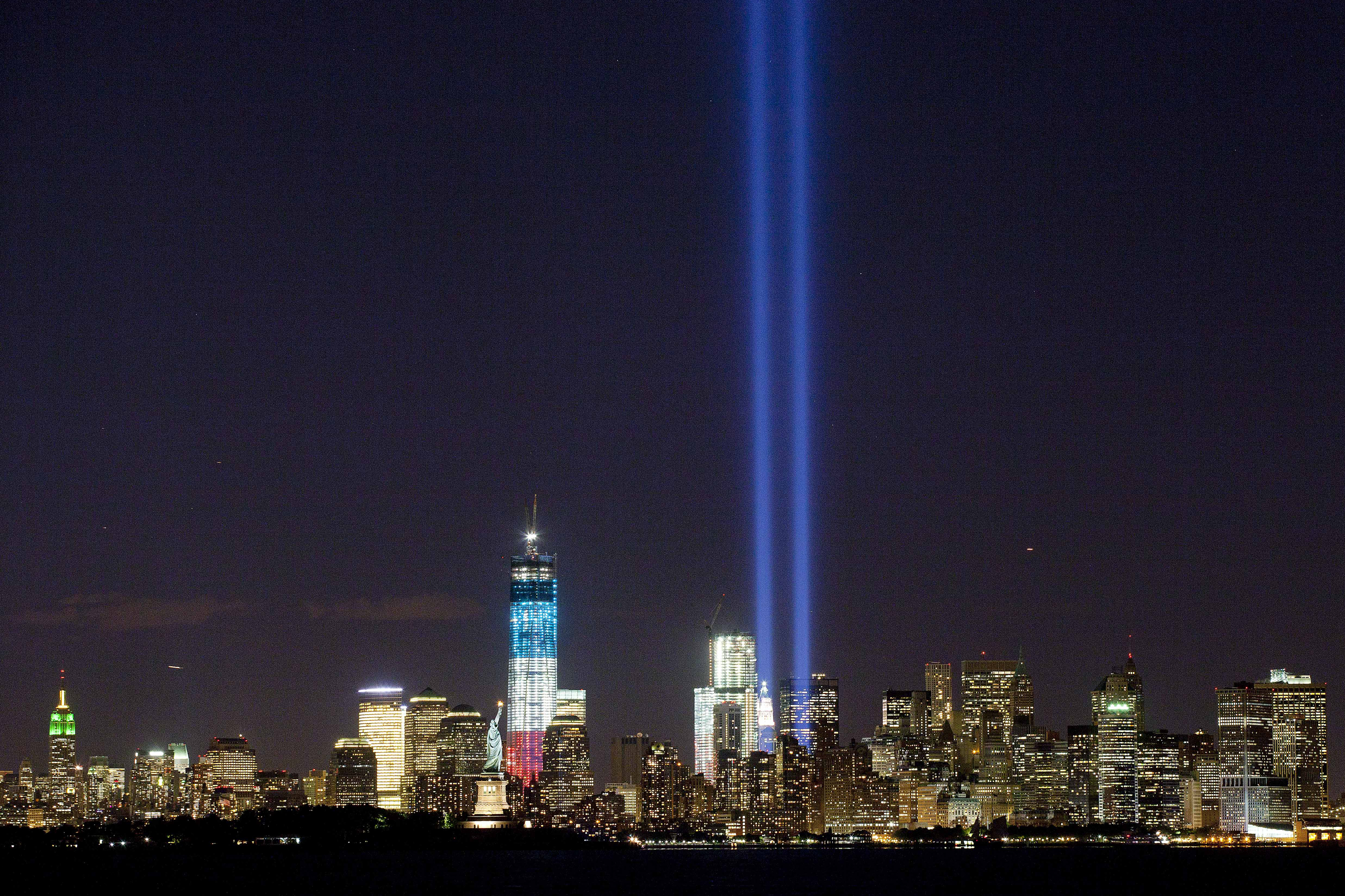 The Tribute in Light shines above the World Trade Center and the Statue of Liberty on Monday as seen from Bayonne, N.J. Tuesday marks the 11th anniversary of the attack that destroyed the twin towers.