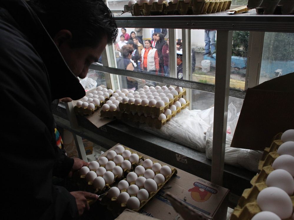 A city worker sells eggs as people line up outside the truck in Mexico City on Aug. 24. The Mexican government is battling an egg shortage that has caused prices to spike in a country with the highest per-capita egg consumption on Earth.