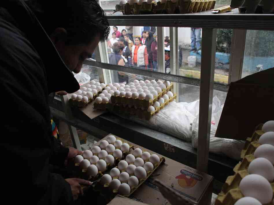 A city worker sells eggs as people line up outside the truck in Mexico City on Aug. 24. The Mexican government is battling an egg shortage that has caused prices to spike in a country with the highest per-capita egg consumption on Earth.