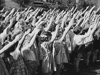 Schoolchildren in Southington, Conn., recite the Pledge of Allegiance in 1942, around the time the custom of placing a hand over the heart replaced the original hand position.