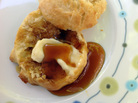Sorghum syrup poured over a buttered biscuit Sorghum syrup poured over a buttered biscuit