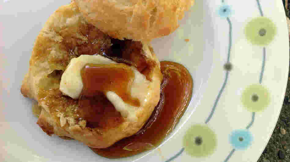 Sorghum syrup poured over a buttered biscuit