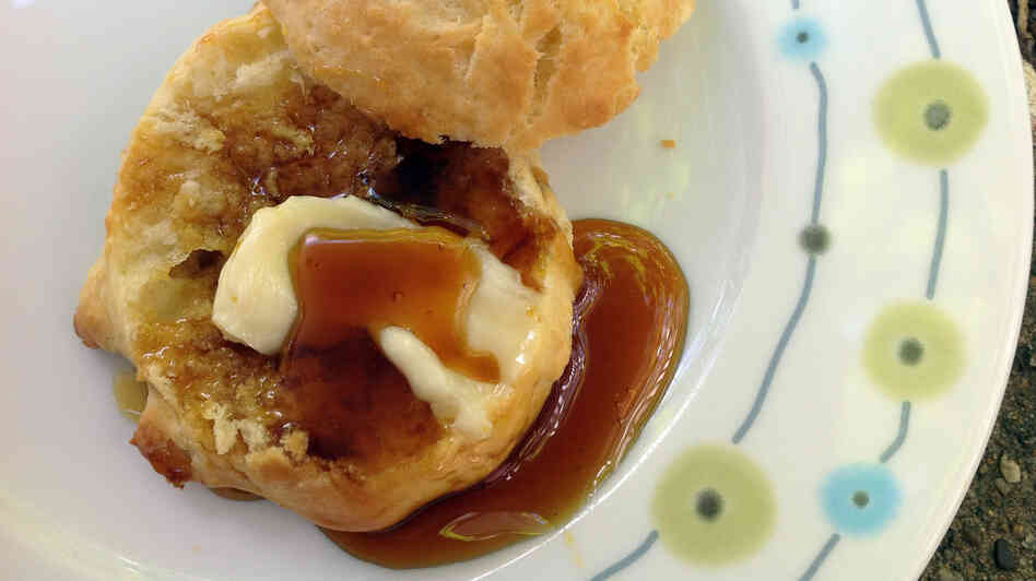 Sorghum syrup poured over a buttered biscuit