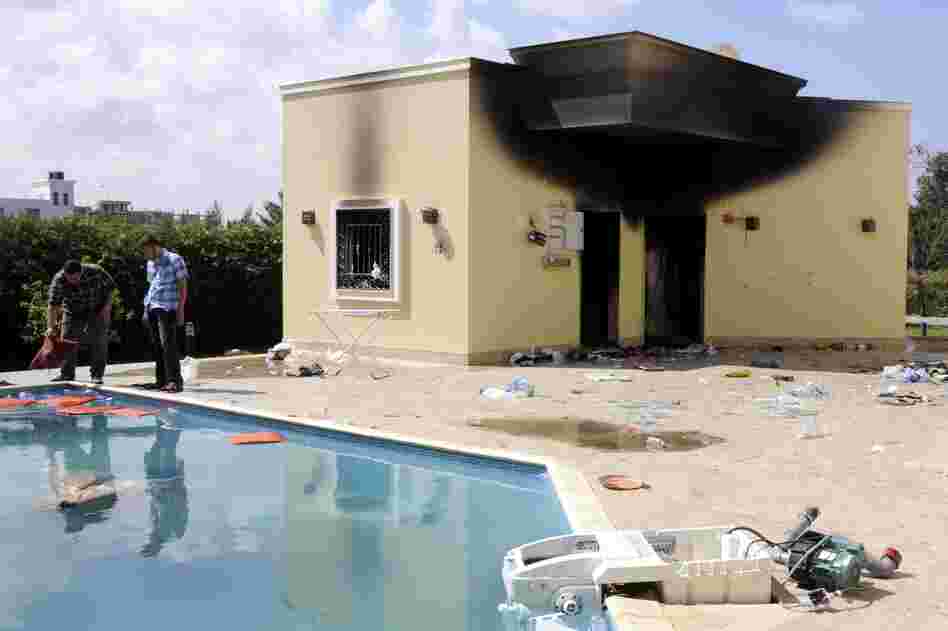 People inspect the damage at the U.S. Consulate, one day after armed men stormed in during a protest over a film they said offended Islam, in Benghazi.