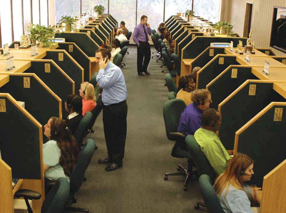 Telemarketers at work at an InfoCision call center. The for-profit company solicits millions in charitable donations each year and also provides marketing services to for-profit clients.