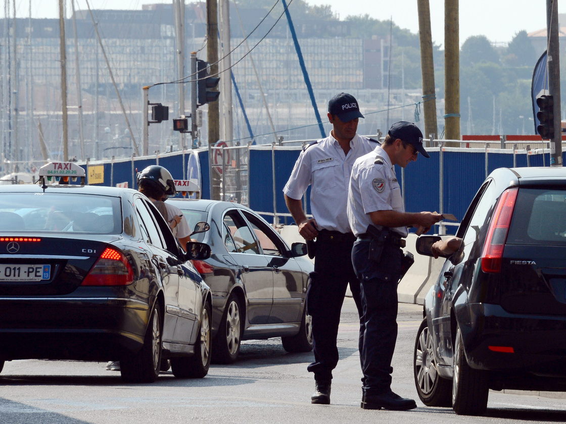 Police officers in Marseille carry out checks on passing cars Sept. 8, two days after the French government announced an increased police presence and the creation of a security zone in the city.