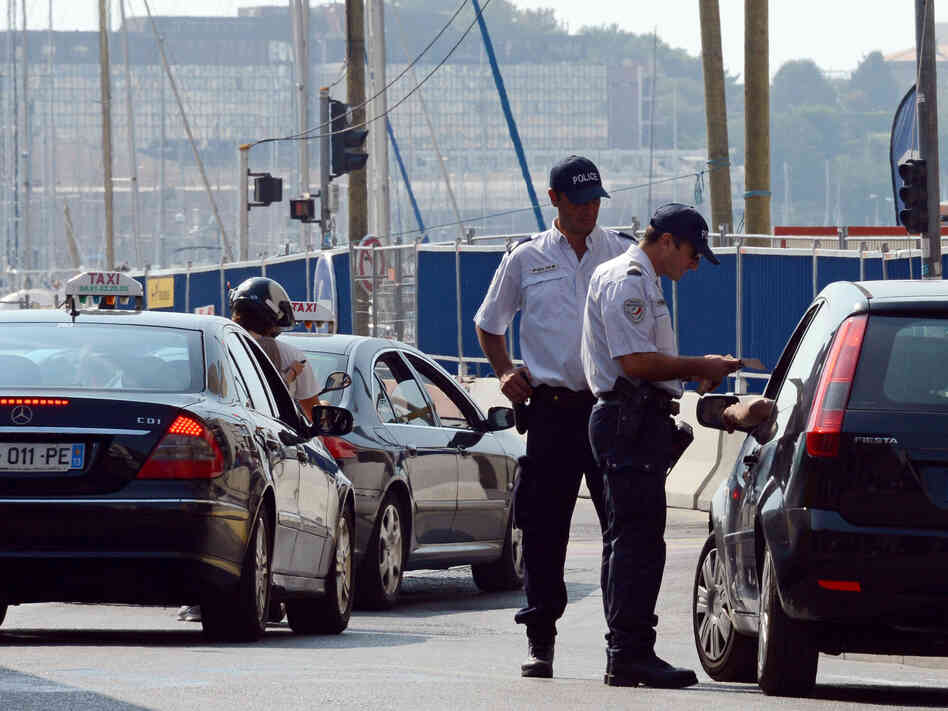 Police officers in Marseille carry out checks on passing cars Sept. 8, two days after the French government announced an increased police presence and the creation of a security zone in the city.