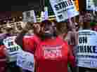 Chicago public school teachers and their supporters picket in front of the Chicago Public Schools headquarters.