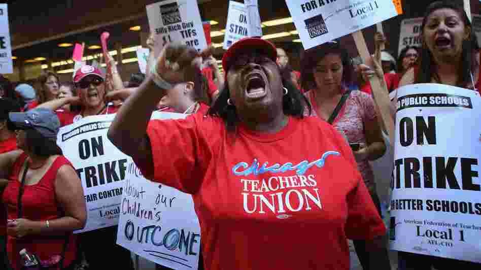 Chicago public school teachers and their supporters picket in front of the Chicago Public Schools headquarters.