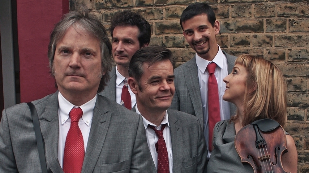 Find the One is the latest album by the alt-bluegrass act The Coal Porters, led by Sid Griffin (far left).