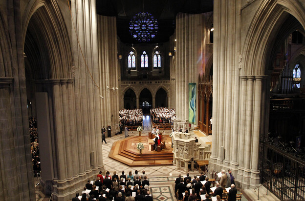 Members of the congregation stand at the Washington National Cathedral in Washington during the national memorial service for the first man to walk on the moon, Neil Armstrong.