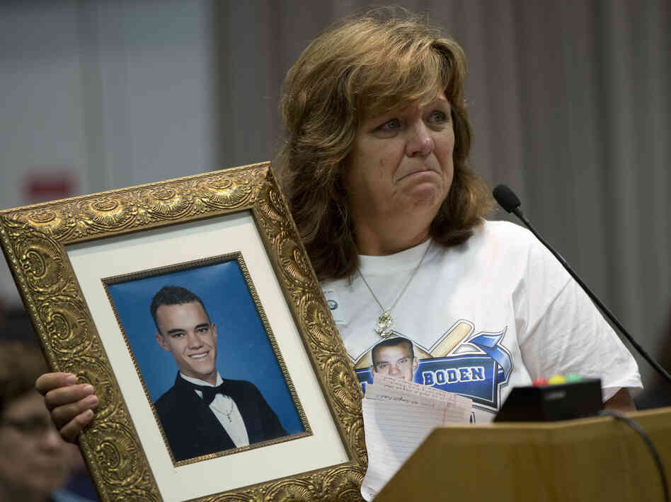 Sandra Boden holds a photo of her son, Jason, during a Task Force on Citizen Safety and Protection hearing. Prosecutors told Boden that Florida's Stand Your Ground law prevented them from filing charges against the person who shot and killed Jason.