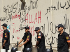 Security guards were deployed outside the graffiti-covered walls of the U.S. Embassy in Cairo, Egypt, which came under attack Tuesday. Security guards were deployed outside the graffiti-covered walls of the U.S. Embassy in Cairo, Egypt, which came under attack Tuesday.